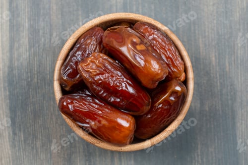 Preview: Dried tasty dates in a wooden bowl