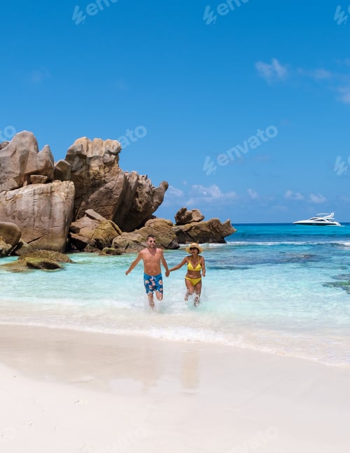 Preview: Anse Cocos La Digue Seychelles, a young couple of men and women on a tropical beach during vacation