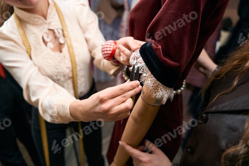 Preview: Dressmaker holds small scissors in her hands