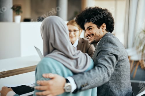 Preview: Happy Middle Eastern man and his wife having consultations with financial advisor in the office.