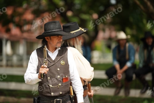 Preview: Brutal cowboy with revolver, gunfight on ranch, rural background.