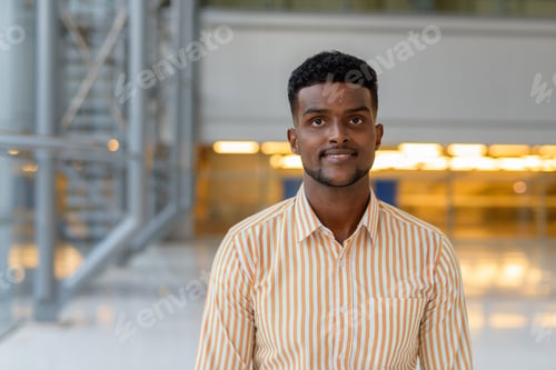Preview: Handsome African man at airport terminal traveling during covid