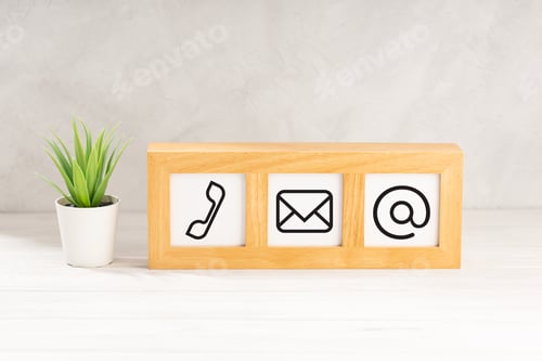 Preview: Contact us icons in modern wooden frame on desk