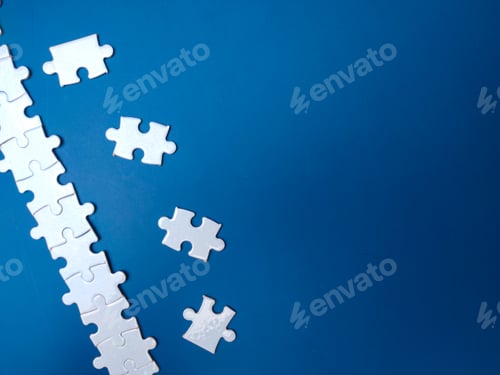 Preview: Unfinished white jigsaw puzzle pieces on blue background
