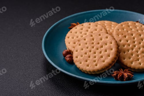 Preview: Round dotted snack snack cookies with cream on a dark concrete background