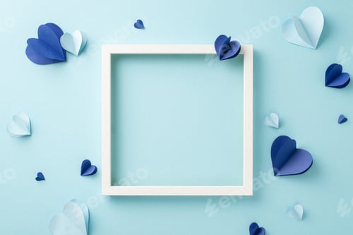 Preview: A creative flat lay with paper hearts and an empty frame arranged on a soft blue backdrop