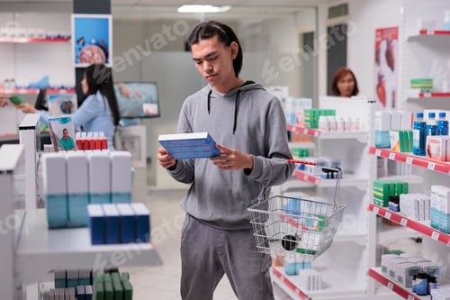 Preview: Young man examining medicaments package