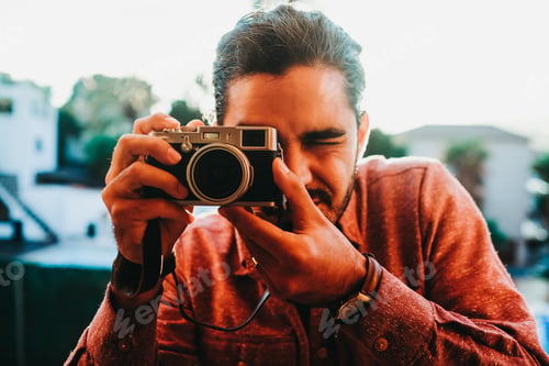 Preview: Man with photo camera on balcony in sunlight