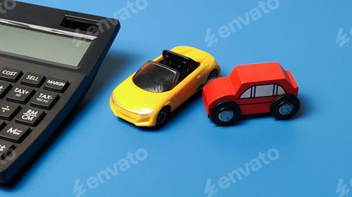 Preview: Car insurance cost and automotive financing concept with toy vehicles and office calculator on blue