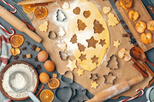 Preview: female hands making cookies from fresh dough at home