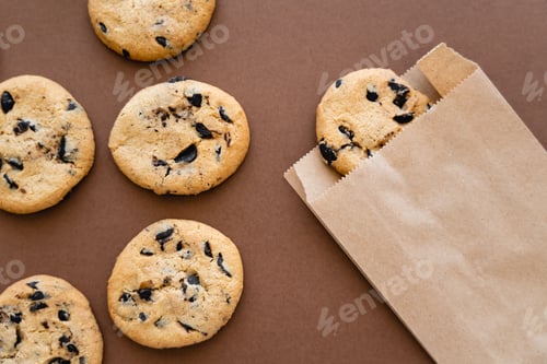 Preview: Top view of cookies and craft package on brown background