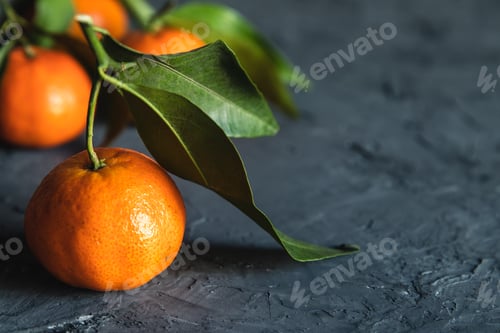 Preview: Juicy ripe tangerines with leaves on wooden table