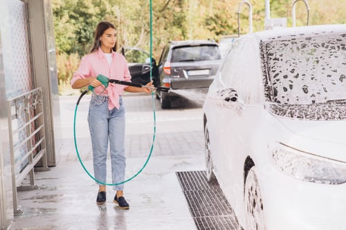 Preview: Young Woman Washing Car at Self Service Car Wash