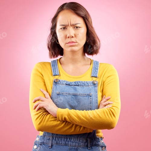 Preview: Portrait, frown and angry asian woman with arms crossed in studio and defensive body language on pi