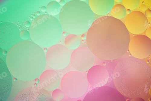 Preview: Abstract yellow, green and pink colorful background with oil on water surface. Oil drops in water