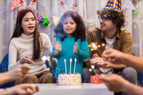 Preview: Celebrating Little girl birthday, blowing candles on homemade baked cake,