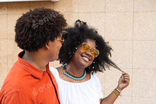 Preview: Cheerful Black Couple Hugging On Street