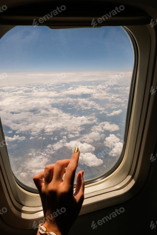 Preview: Female hand Airplane flight. View from the window of the plane. Airplane, Aircraft. Vacation travel