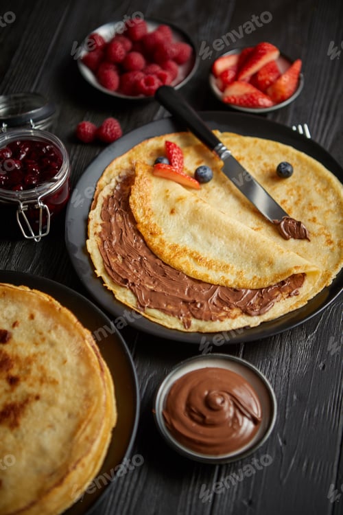 Preview: Delicious chocolate homemade pancakes on black ceramic plate