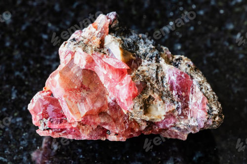 Preview: sample of raw rhodonite mineral on black