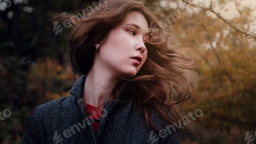 Preview: Beautiful Asian woman in a golden autumn forest.