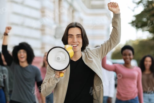 Preview: Cheerful young man with loudspeaker leading international group of students