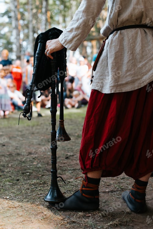 Preview: Folk concert outdoor music festival. Close-up of a male musician in a medieval costume holding