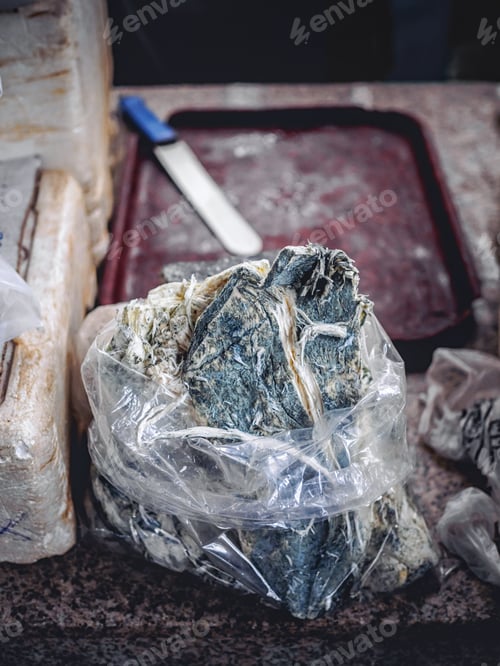 Preview: close-up shot of homemade molded chechil cheese selling on armenian market