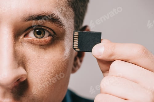 Preview: selective focus of man implanting microchip in head isolated on grey