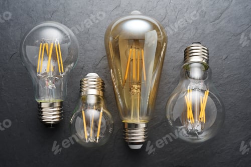 Preview: Transparent LED filament light bulbs on black background.