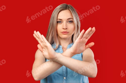 Preview: Young woman showing two hands stop gesture isolated on color background