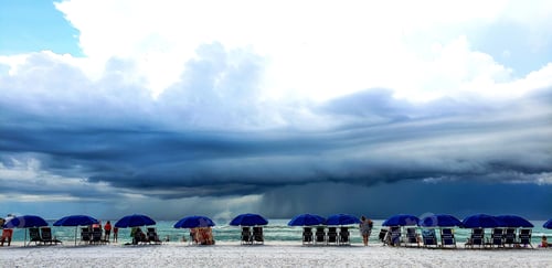 Preview: Beautiful sky with threatening rain clouds on seashore of vacation getaways at Florida beach.