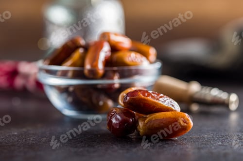 Preview: Dried dates fruit on black table.