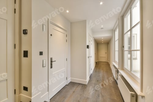 Preview: a hallway with white doors and windows and a wood