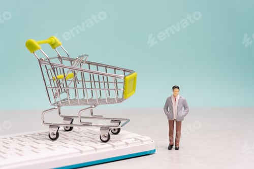 Preview: Miniature Figurine Beside Shopping Cart on Keyboard