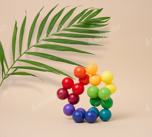 Preview: Abstract background with multi-colored plastic balls on a beige background