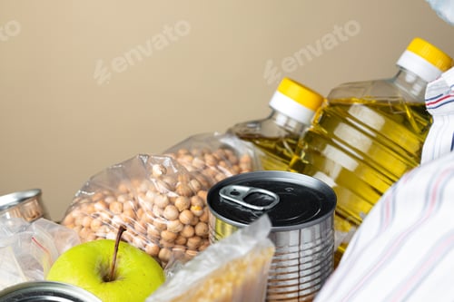 Preview: Set of raw cereals, grains, pasta and canned food on the table.