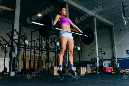 Preview: Determined sportswoman lifting heavy barbell