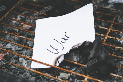 Preview: Word war writen in a white paper in burn ashes and charcoal