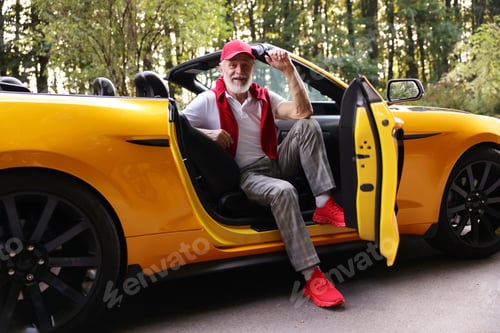 Preview: Stylish senior man in modern cabriolet outdoors