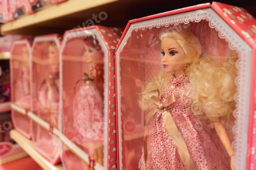 Preview: dolls in pink dresses on the shelf of a toy store. happy childhood