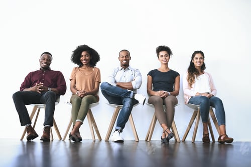 Preview: Smiling Young Adults Sitting Waiting in a Bright Room