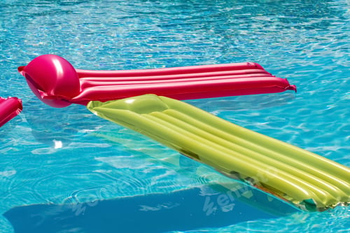 Preview: Vacation travel concept with inflatable float toy mattress in luxury swimming pool. Luxury lifestyle