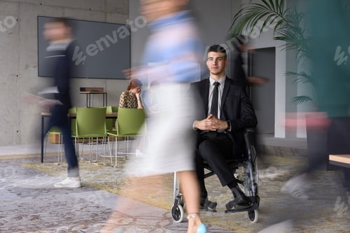 Preview: A businessman in a wheelchair navigating through a busy office, surrounded by his colleagues who are