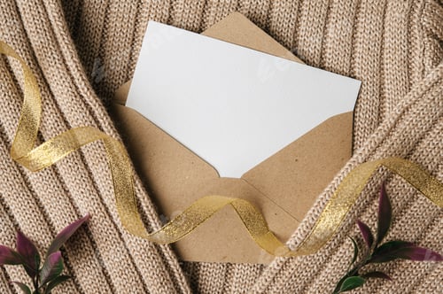 Preview: A blank card is placed on envelope and a sweater
