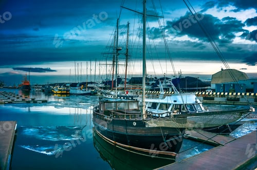 Preview: Bright summer evening at a boat harbor in Klaipeda, Lithuania with boats parked on the water