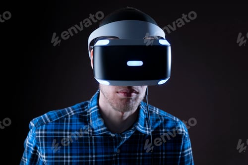 Preview: using a virtual reality glass kit in dark, male person using innovative futuristic gadget with neon