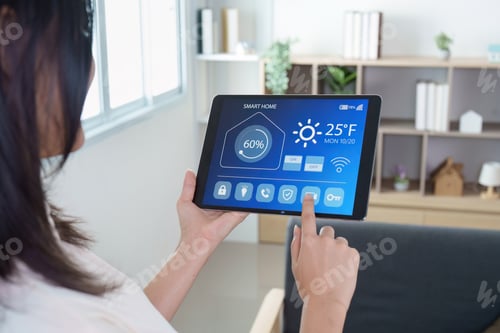 Preview: Smart Home. Woman controlling smart home system on tablet.