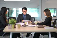 Preview: Group of businesspeople collaborating and exchanging ideas in a bright office