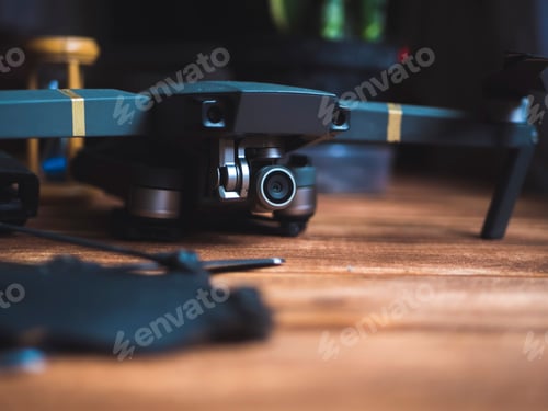 Preview: close up quadrocopter device kit on a wooden surface with dark background